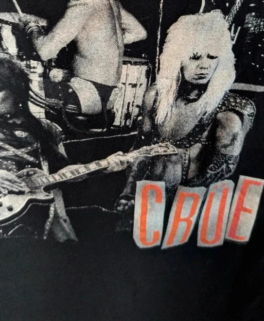 Mötley Crüe black graphic tee featuring retro collage artwork and red block logo.
