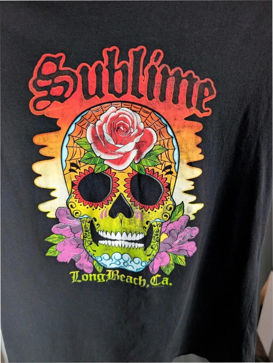 Sublime graphic tee black featuring vibrant sugar skull print with roses and gothic lettering.