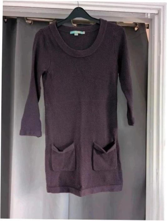 Purple knit sweater dress with long sleeves, relaxed fit, and functional front pockets.