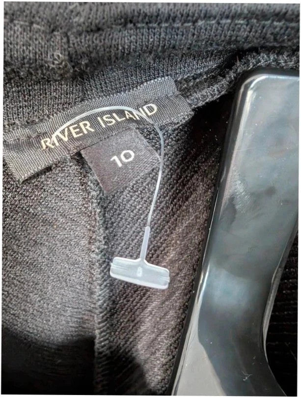River Island black bodycon mini dress with ribbed texture and midriff cut-out detail.