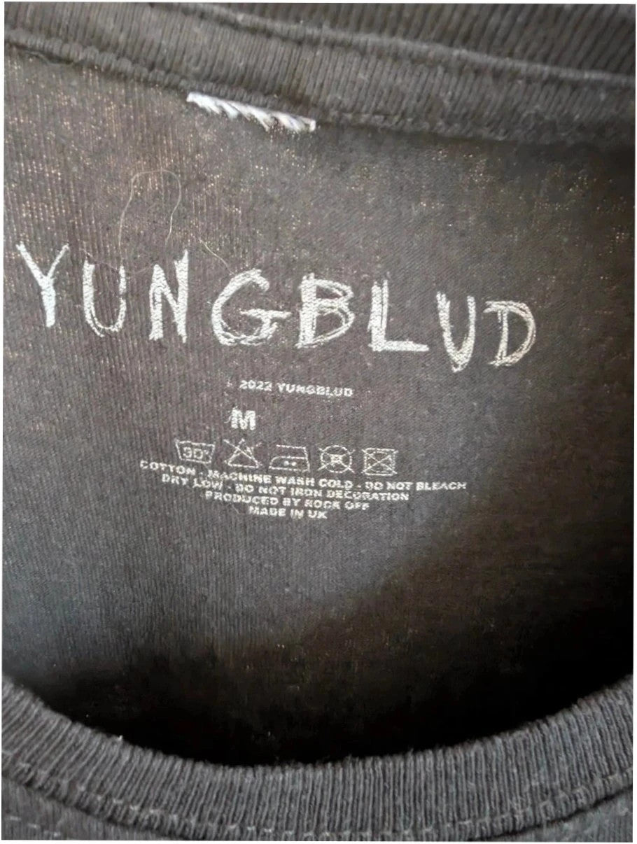 Yungblud black graphic tee with metallic silver portrait and neon pink tour lettering.