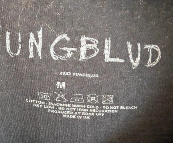 Yungblud black graphic tee with metallic silver portrait and neon pink tour lettering.
