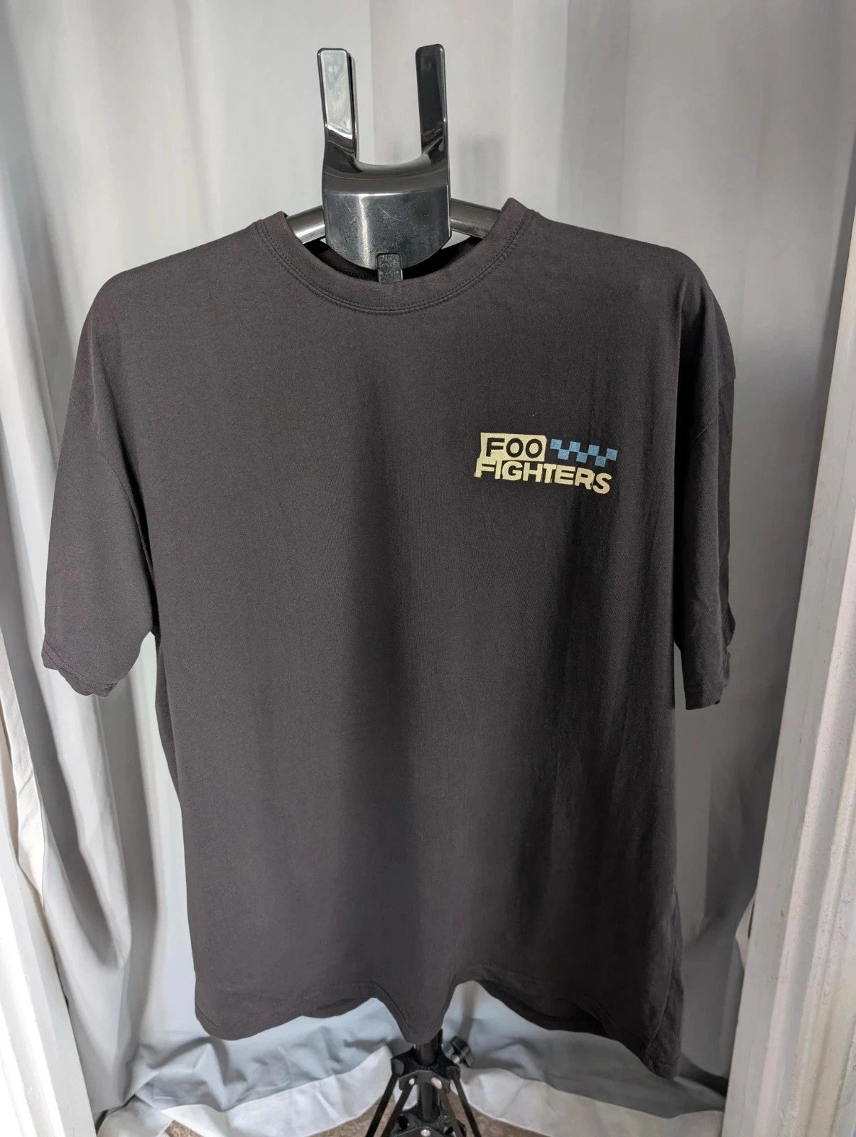 Foo Fighters black graphic tee with coiling snake and checkerboard pattern, soft cotton.