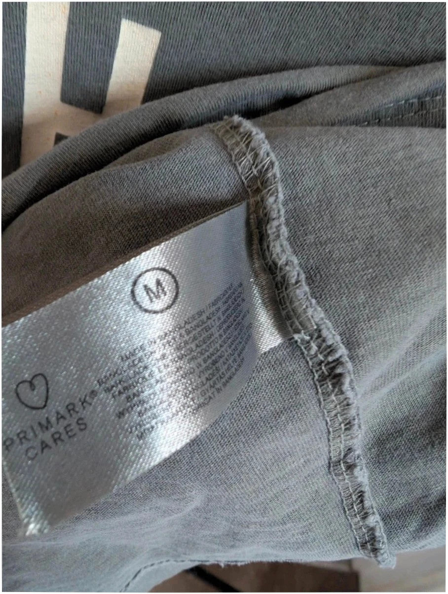 Miles Davis grey graphic tee featuring "So What 1959" typography and trumpet artwork.