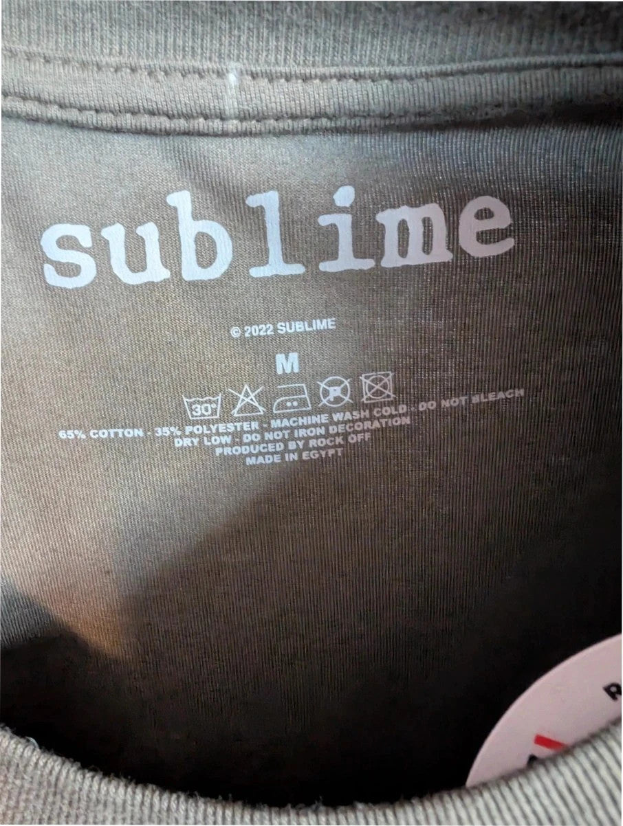 Sublime khaki graphic t-shirt featuring distressed sun artwork and bold red logo print.