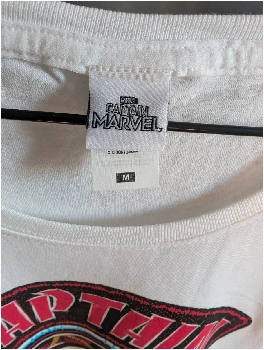 Marvel white graphic t-shirt featuring Captain Marvel print and retro patch-style lettering.