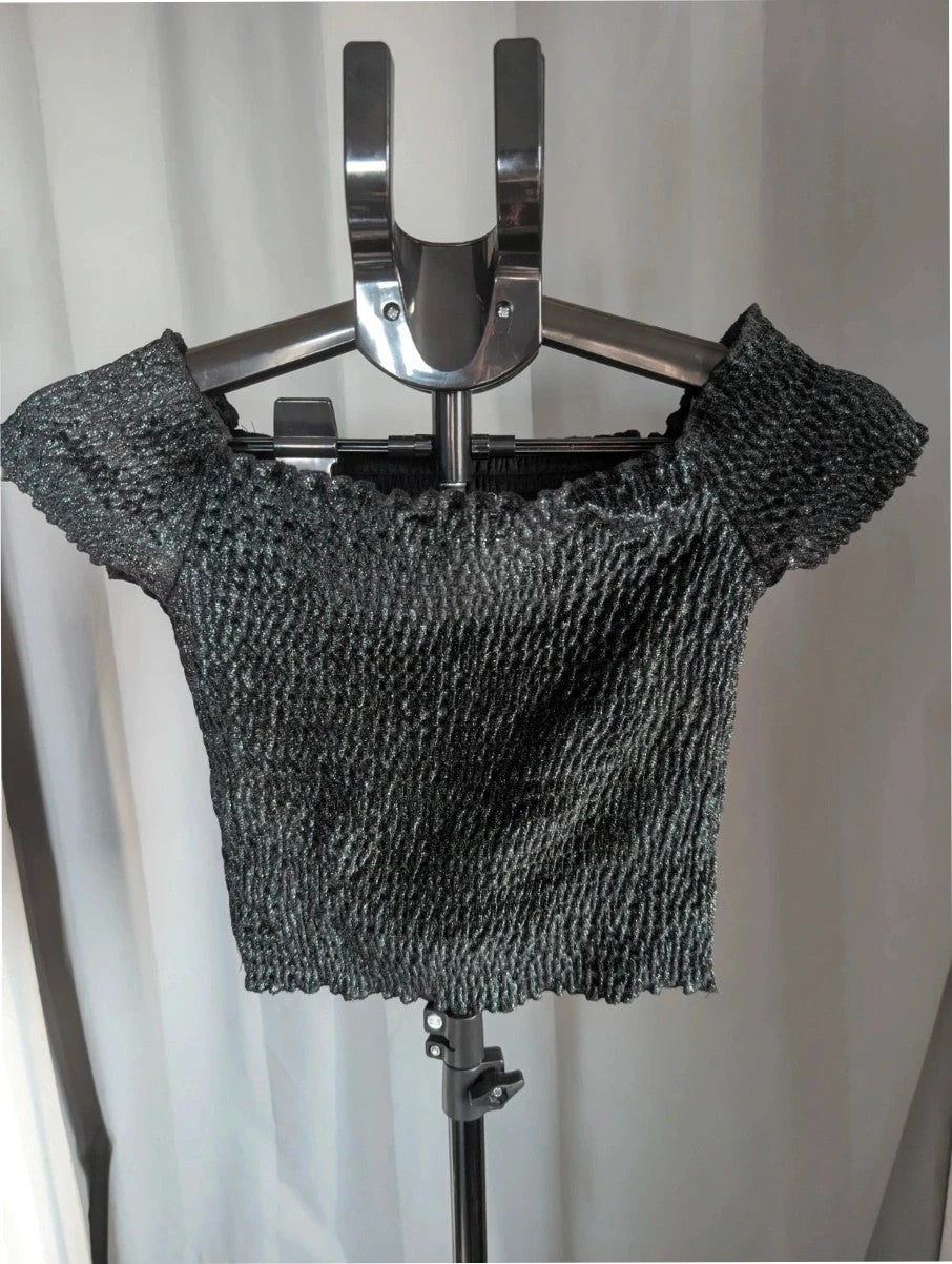 Light Before Dark black and silver smocked crop top with metallic shimmer and ruffle trims.