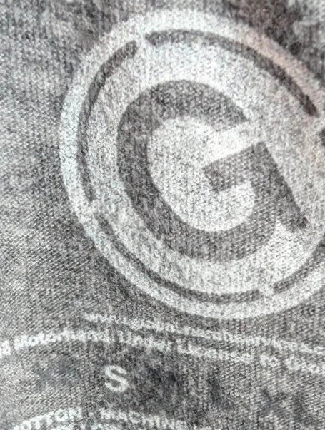 Motörhead grey graphic tee featuring Snaggletooth Warpig emblem and circular print.
