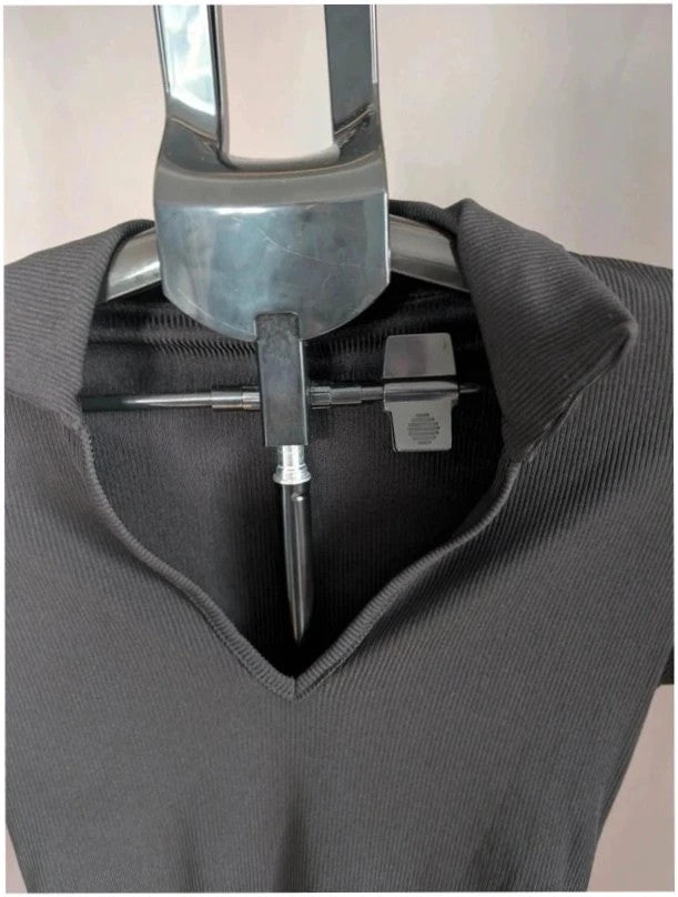 Select black ribbed long sleeve collared bodysuit with deep v-neck and popper fastenings.