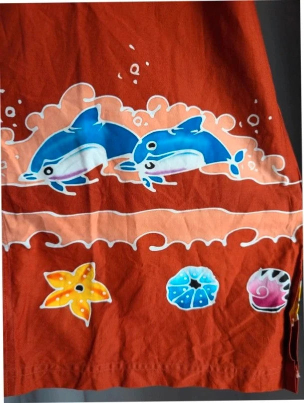 Phuket Batik burgundy graphic tee with hand-painted dolphins and commemorative embroidered pocket.