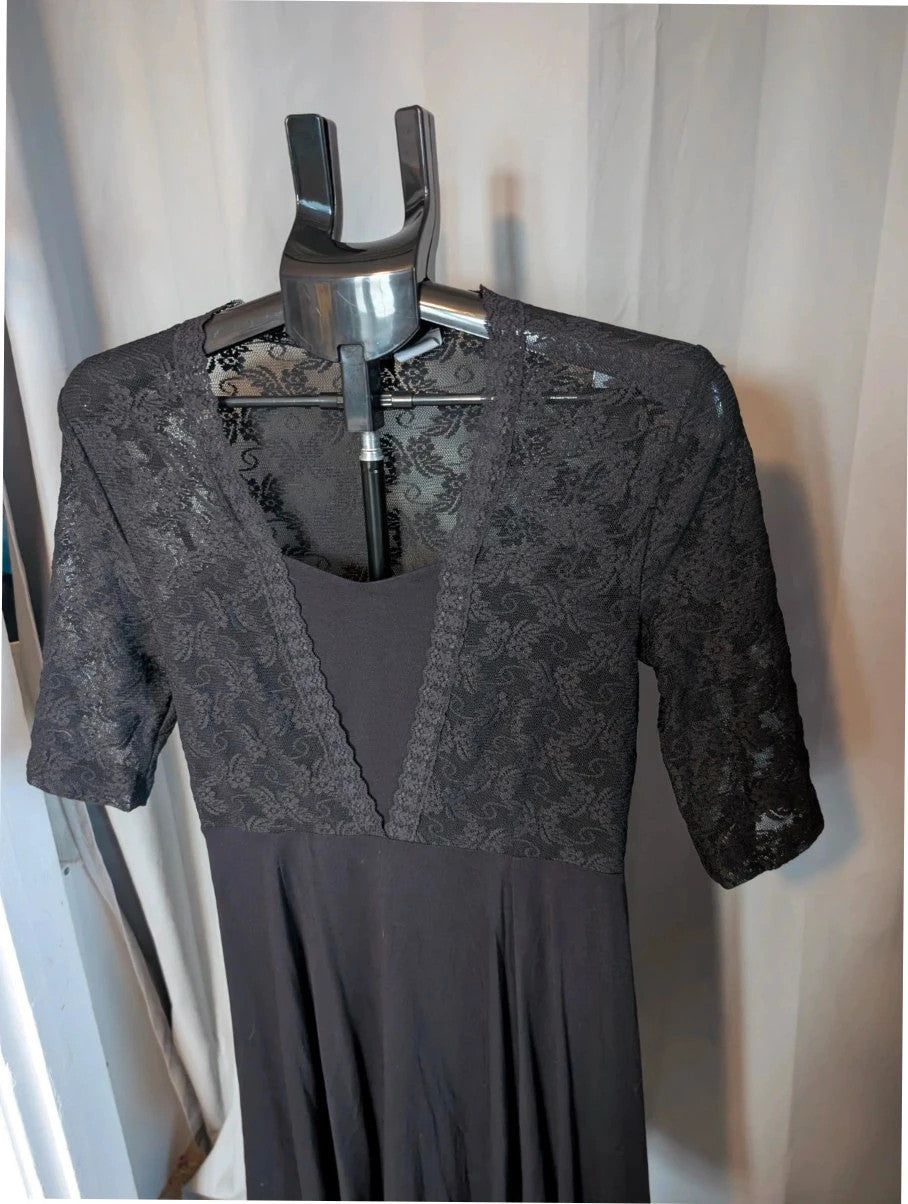 Bodyflirt black skater dress with floral lace yoke, deep V-neckline, and pleated skirt.