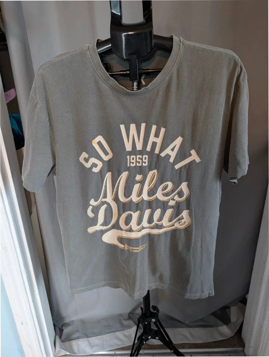Miles Davis grey graphic t-shirt with "So What 1959" typography and trumpet artwork.