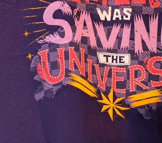 Marvel graphic t-shirt purple featuring "Sorry I'm Late" text and Captain Marvel star motif.