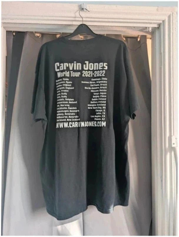 Official Carvin Jones black graphic tee featuring bold guitar artwork and tour dates print.