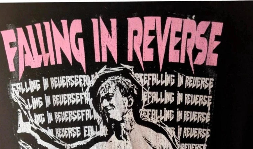 Next Level black graphic tee featuring Falling In Reverse pink logo and band portrait.