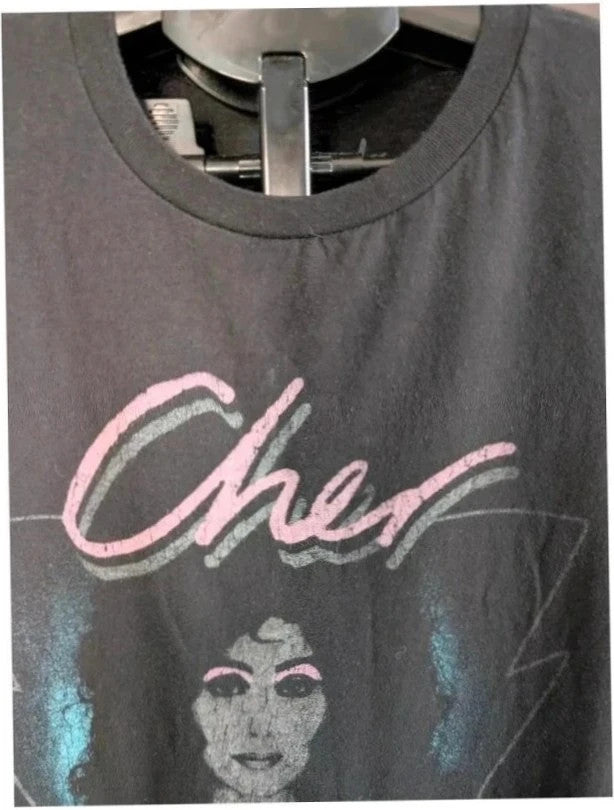 Bravado black graphic t-shirt featuring Cher portrait print with pink and blue accents.