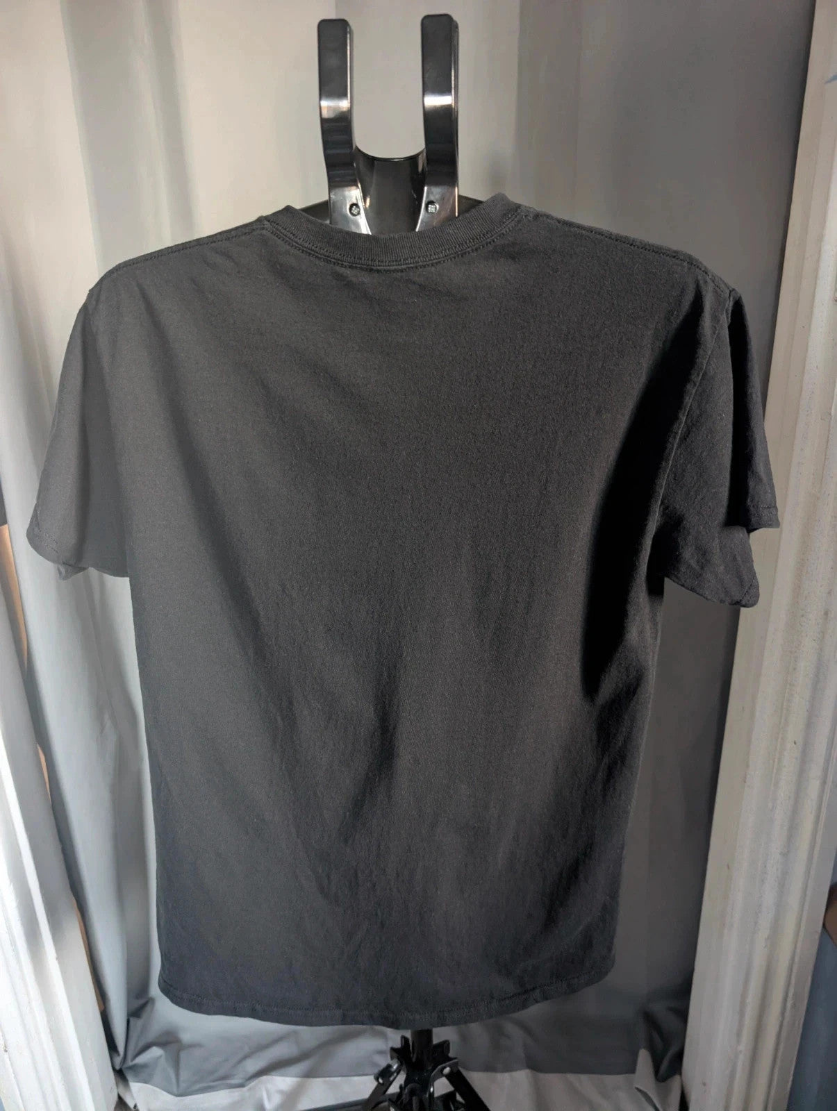 Naruto black graphic t-shirt featuring Kakashi Hatake, bubble typography, and Sharingan eye design.