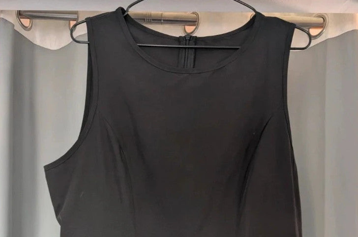 SHEIN black sleeveless mini dress with front flap pockets and back zip fastening.