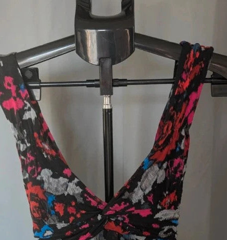 Rise black linen maxi dress with vibrant pink floral print and twist front V-neck.