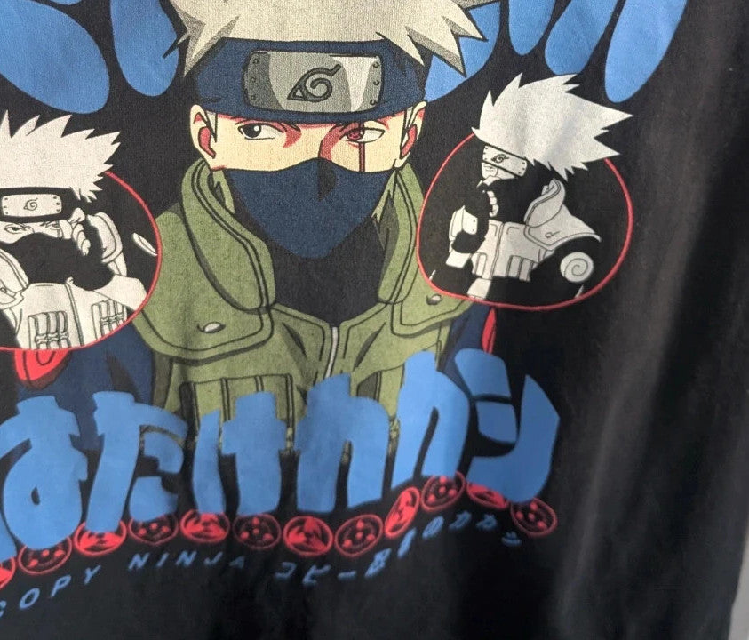 Naruto black graphic t-shirt featuring Kakashi Hatake, bubble typography, and Sharingan eye design.