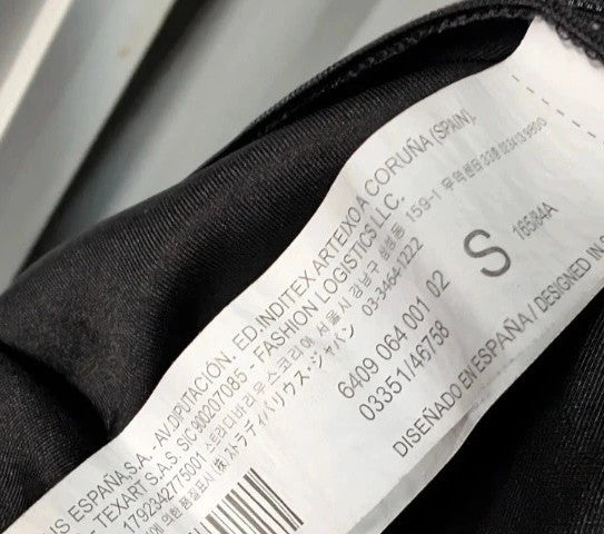 Stradivarius black satin pencil dress with twist front, collared V-neck, and long sleeves.