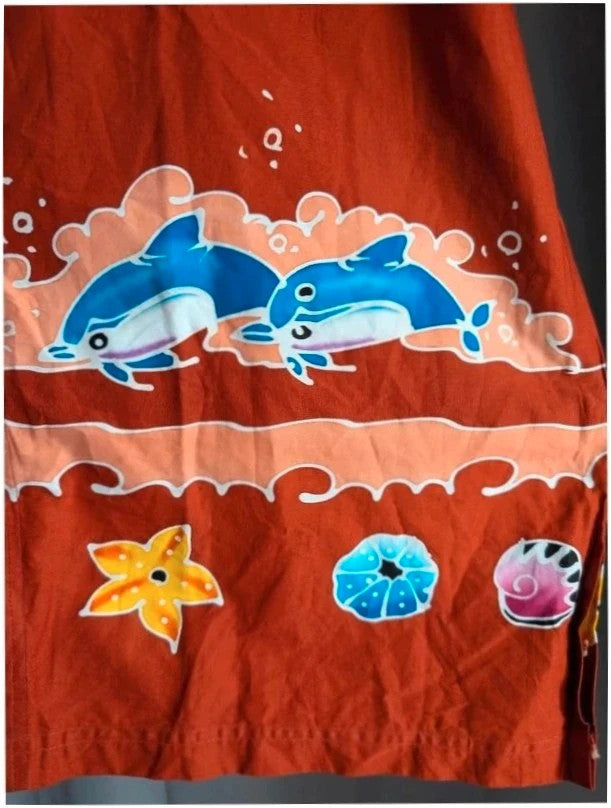 Phuket Batik burgundy graphic tee hand-painted dolphins and embroidered chest pocket detail.
