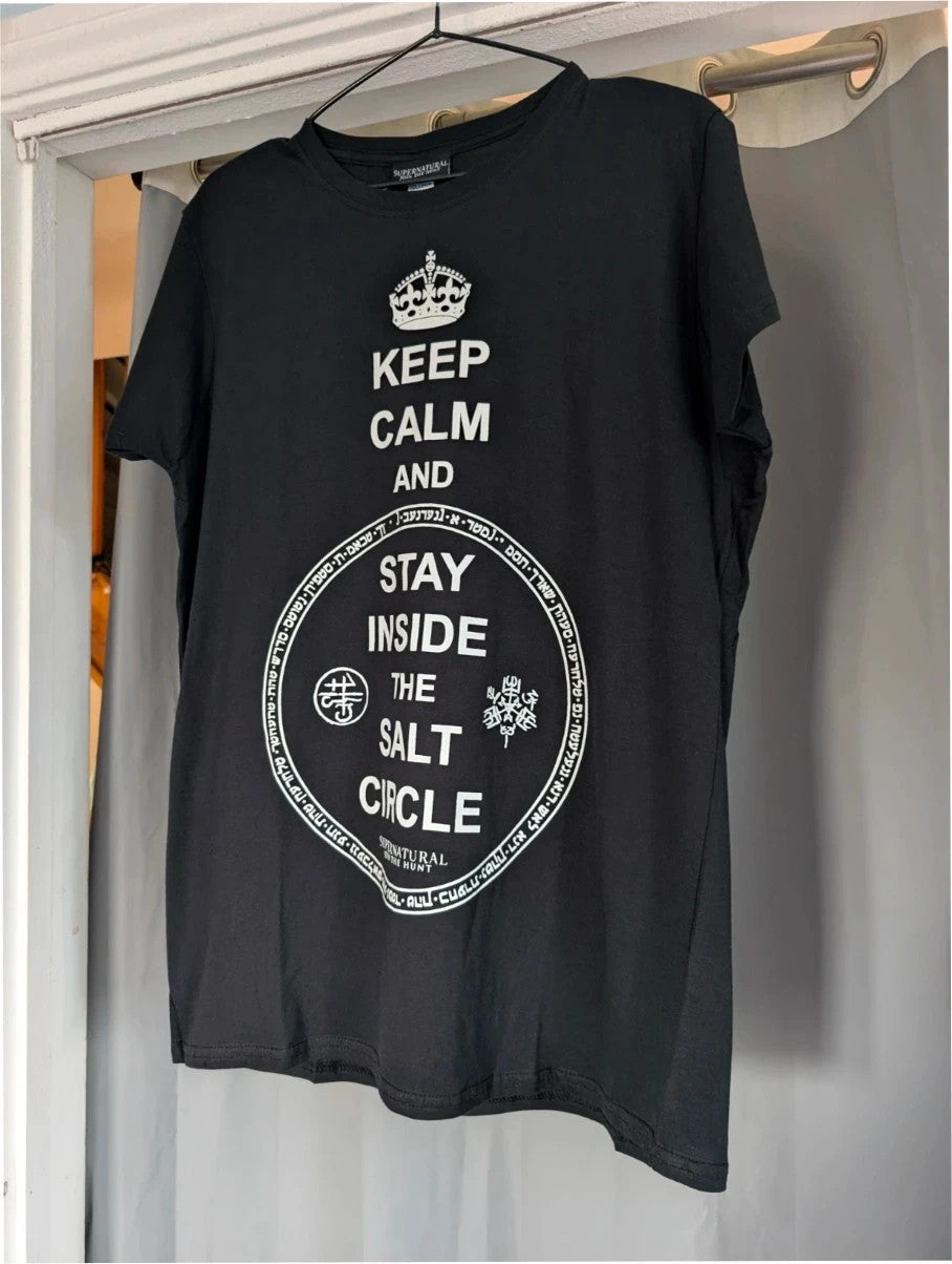 Supernatural black pocket t-shirt with "Stay Inside Salt Circle" graphic and symbols.