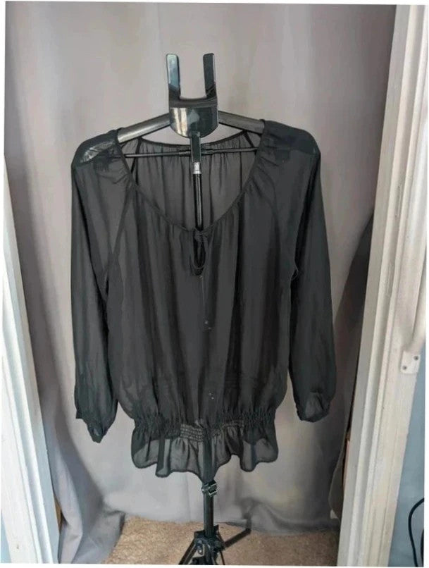 Next black sheer long sleeve blouse with tie neck and ruffle hem detail.