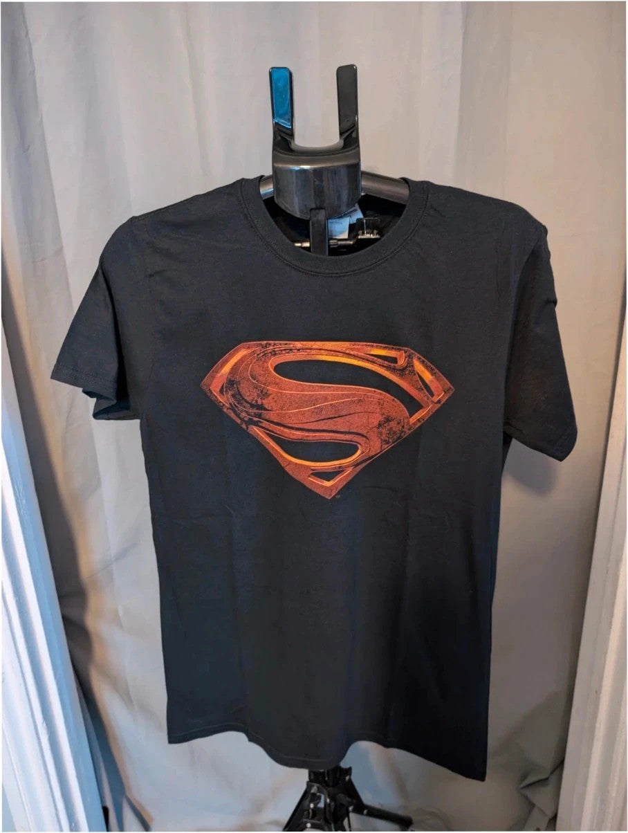 Superman black graphic tee with distressed metallic orange shield logo on soft cotton.