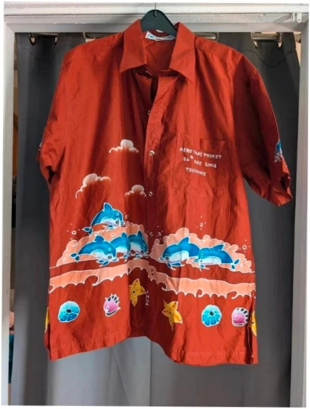 Phuket Batik burgundy graphic tee hand-painted dolphins and embroidered chest pocket detail.