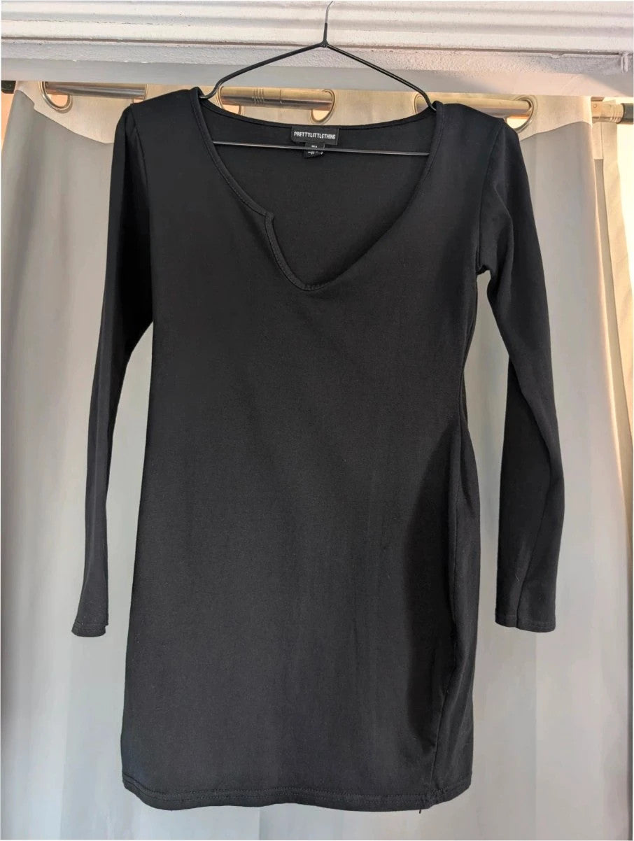 PrettyLittleThing black long sleeve bodycon mini dress with notch neck and fitted sleeves.
