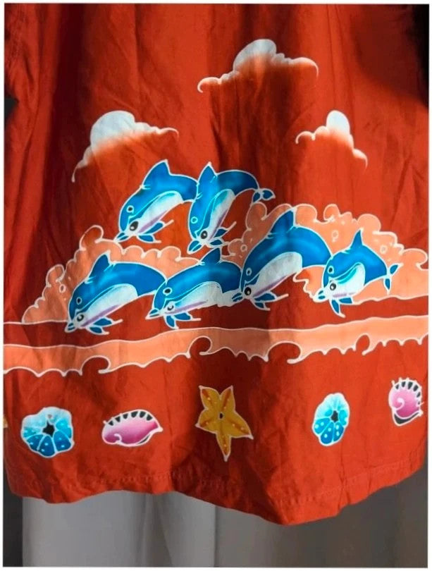 Phuket Batik burgundy graphic tee hand-painted dolphins and embroidered chest pocket detail.