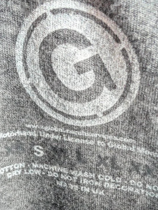 Motörhead grey graphic tee featuring Snaggletooth Warpig emblem and circular print.