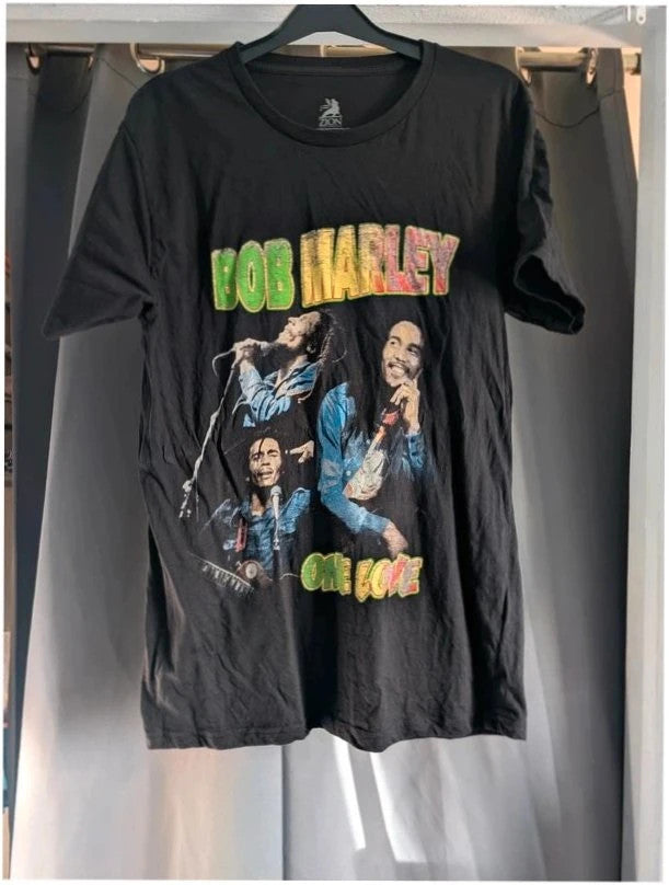 Zion Rootswear black graphic t-shirt featuring Bob Marley portraits and distressed Rasta font.