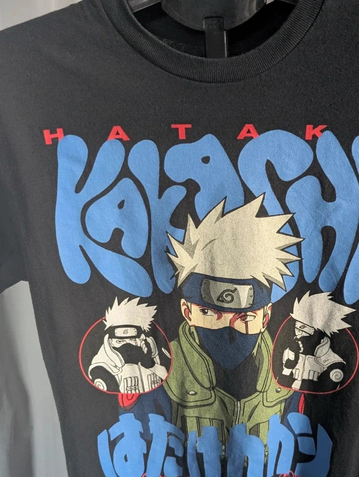 Naruto black graphic t-shirt featuring Kakashi Hatake, bubble typography, and Sharingan eye design.