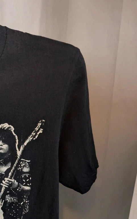 Mötley Crüe black graphic tee featuring retro band collage and red logo lettering.