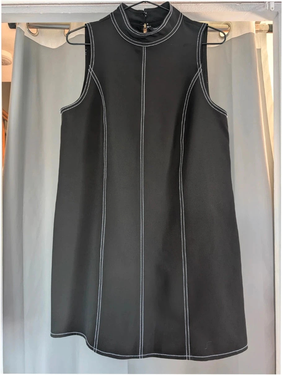 River Island black sleeveless mini dress with white contrast stitching and mock neck collar.
