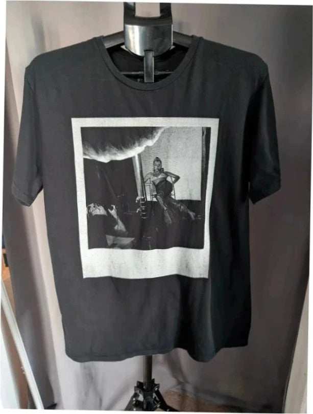 Dua Lipa black graphic tee with front polaroid print and back tour dates list.