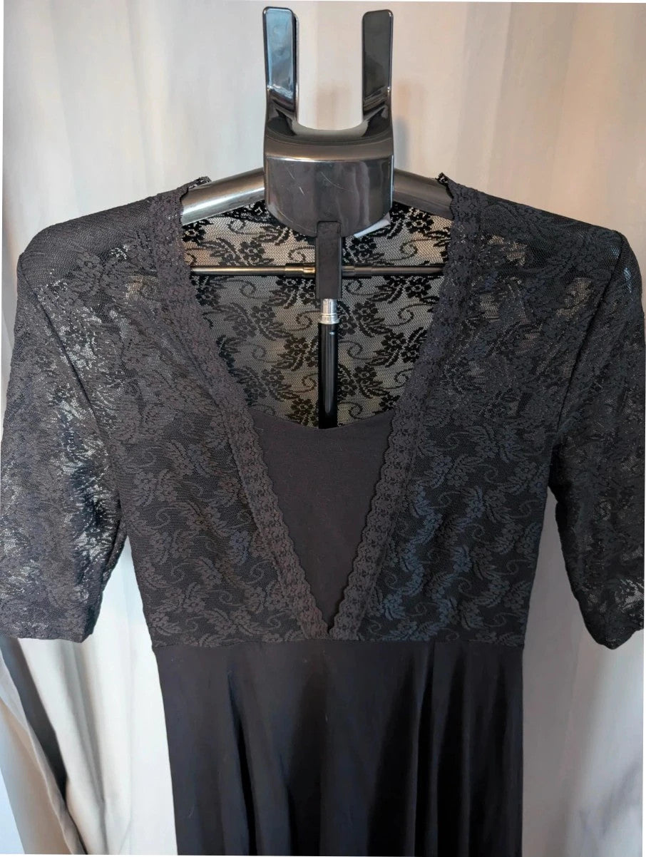 Bodyflirt black skater dress with floral lace yoke, deep V-neckline, and pleated skirt.