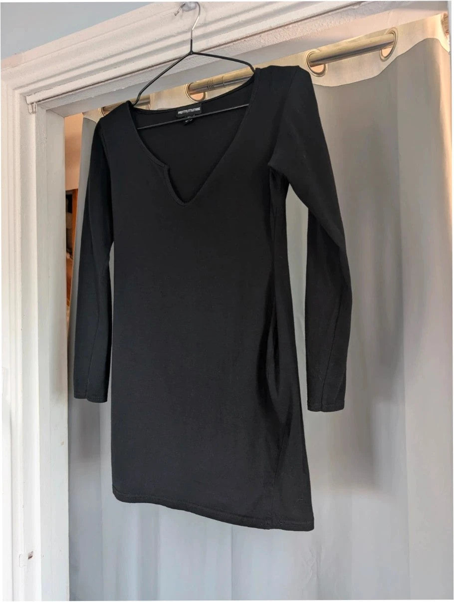 PrettyLittleThing black long sleeve bodycon mini dress with notch neck and fitted sleeves.