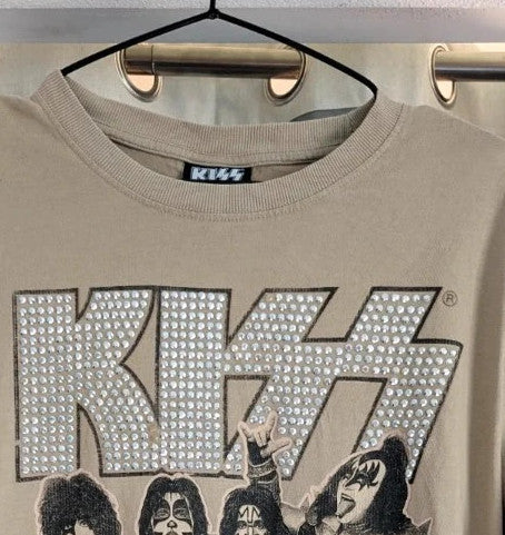 Kiss beige pocket t-shirt with rhinestone logo and band photo graphic.