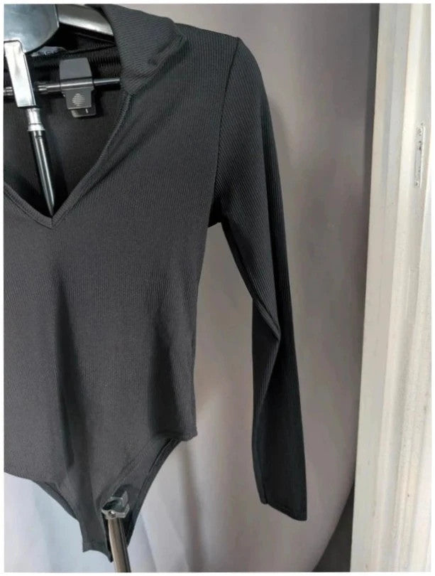 Select black ribbed long sleeve collared bodysuit with deep v-neck and popper fastenings.