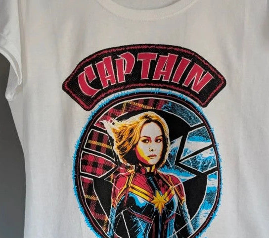 Marvel white graphic t-shirt featuring Captain Marvel print and retro patch-style lettering.