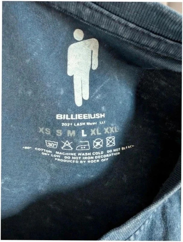 Billie Eilish blue acid wash pocket t-shirt with multicolour graphic and red text.