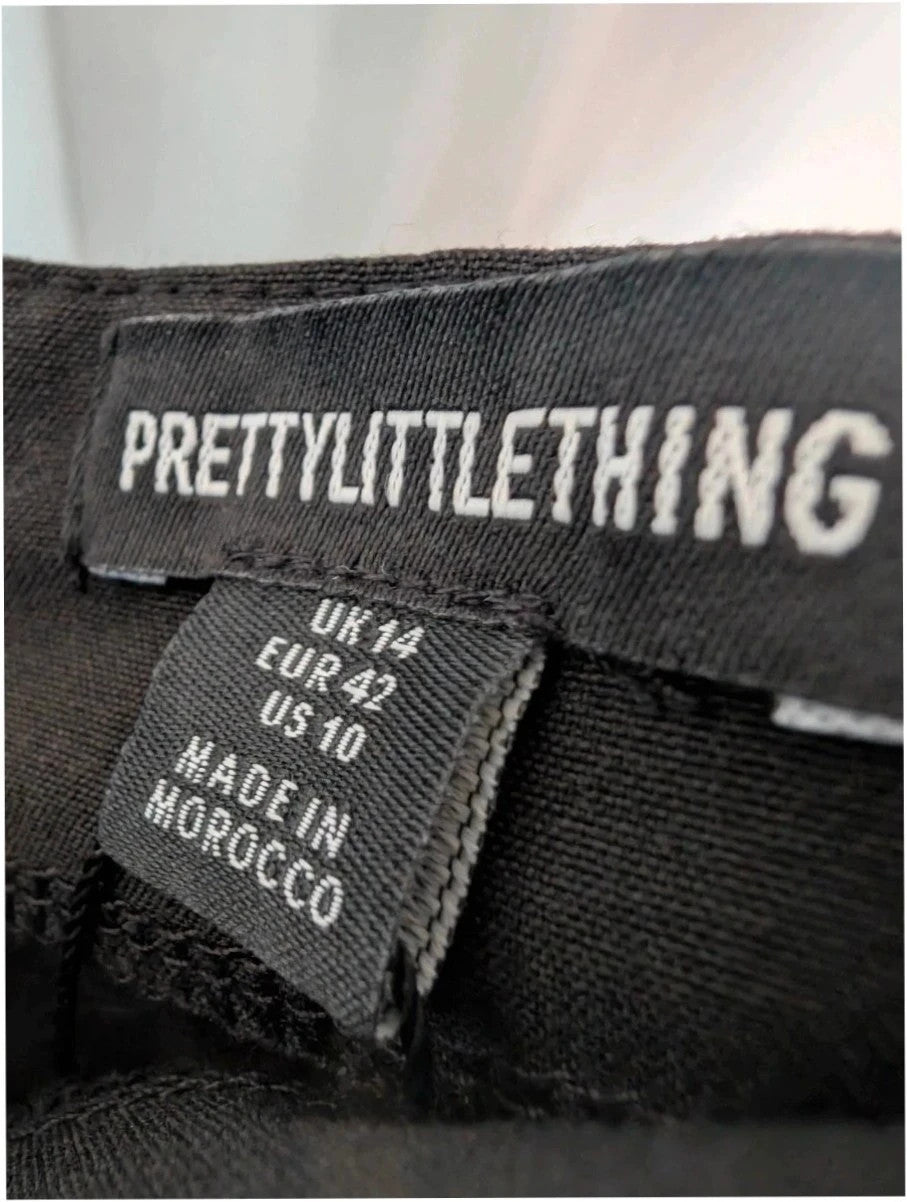 PrettyLittleThing black mini skirt with white satin bow detail and high-waisted fit.