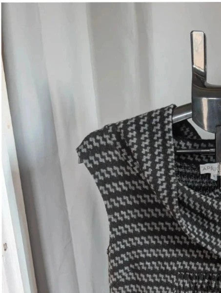 Apricot black and grey knit tunic dress with cowl neck and geometric pattern.